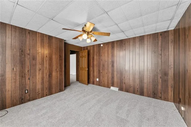 a view of a livingroom with a ceiling fan and window