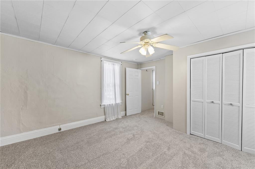 807 Oak Street Monessen, PA 15062 - Photo 20 of 28 an empty room with chandelier fan