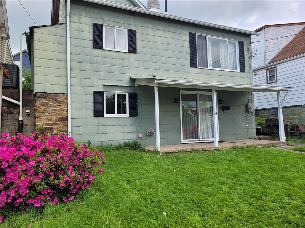 807 Oak Street Monessen, PA 15062 - Photo 27 of 28 a view of a house with brick walls and a yard with potted plants