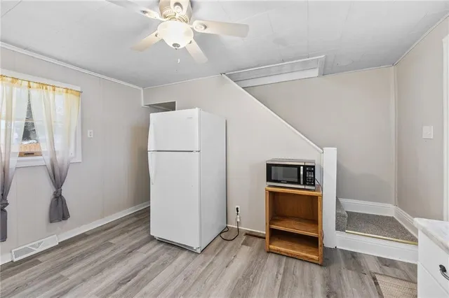 a kitchen with granite countertop white cabinets and white appliances