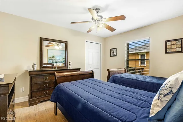 a bedroom with two beds and a dresser