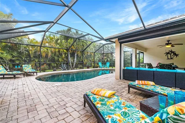 a view of swimming pool with a couches chairs and city view