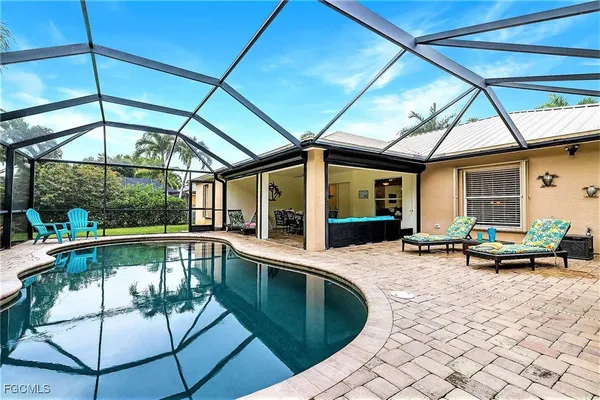 a view of a patio with a table and chairs under an umbrella