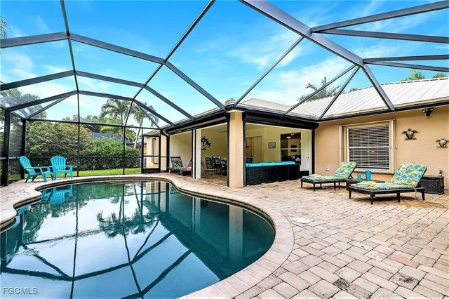 a view of a patio with a table and chairs under an umbrella