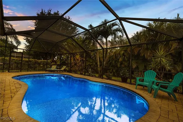a view of a swimming pool with a patio and a fountain