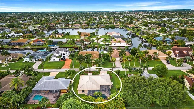 an aerial view of residential houses with outdoor space and pool
