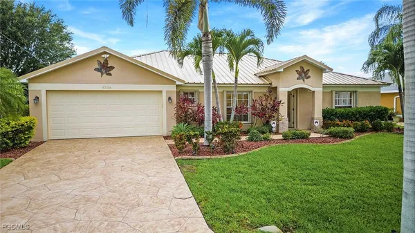 a front view of house with yard and green space