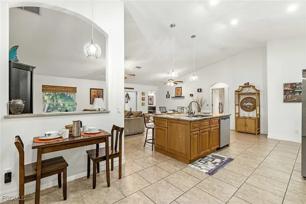 a kitchen with granite countertop a table and chairs in it