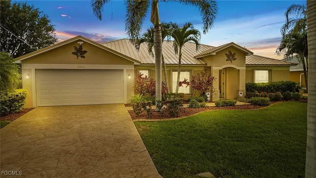 a front view of house with yard and green space