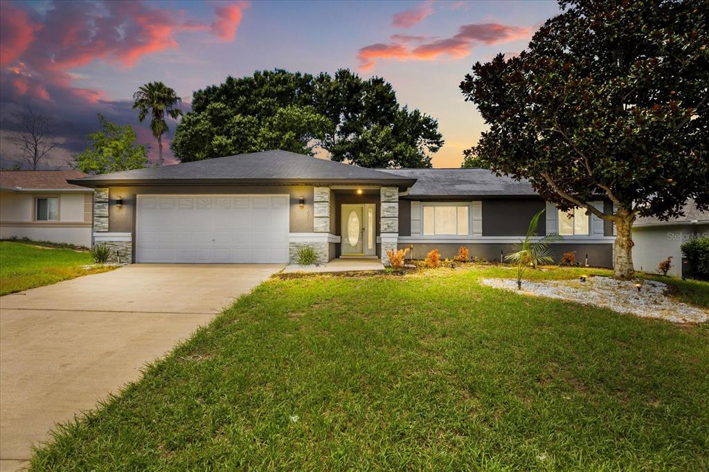 a front view of house with yard and green space
