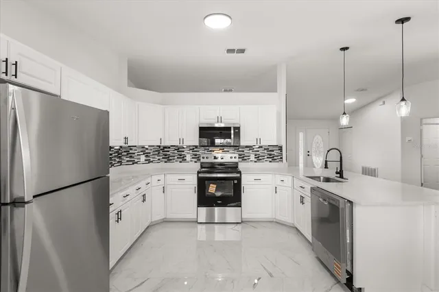 a kitchen with white cabinets and white appliances