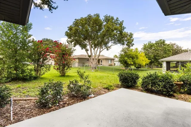 a view of a house with a yard patio and fire pit