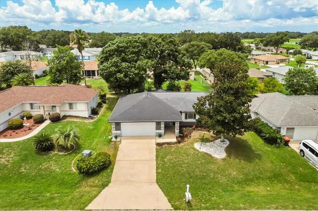 an aerial view of residential houses with outdoor space and swimming pool