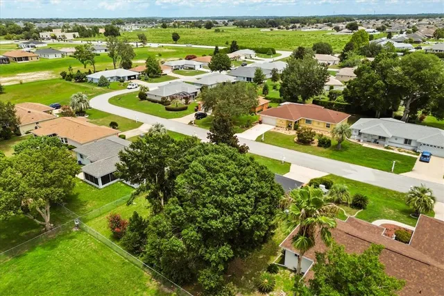 an aerial view of residential houses with outdoor space and garden