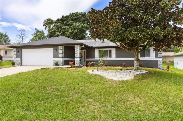 a front view of house with yard and green space