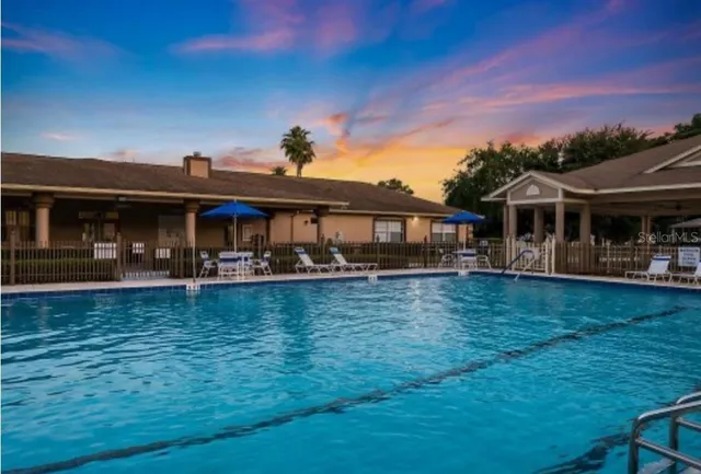 a swimming pool with outdoor seating