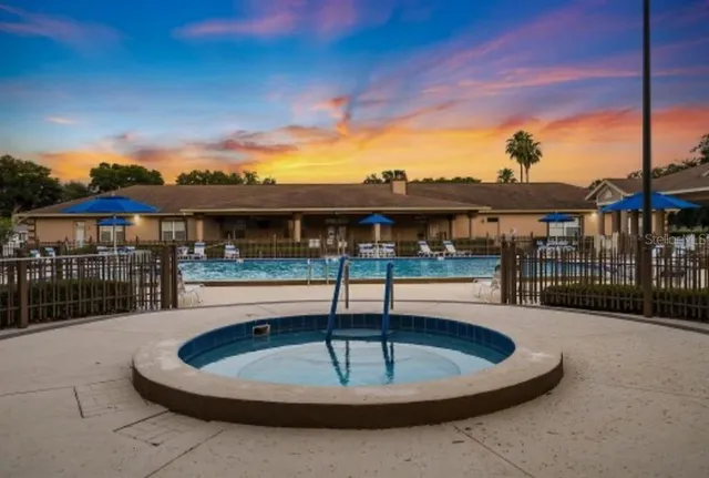 a view of a swimming pool with an outdoor space and seating area