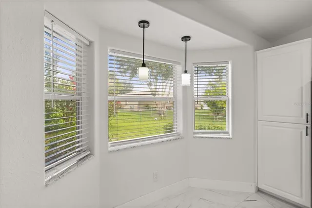 a view of an empty room with windows