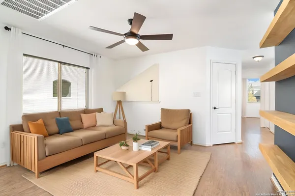 a living room with furniture and a wooden floor
