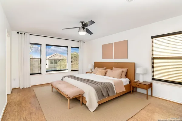 a spacious bedroom with a bed and a window