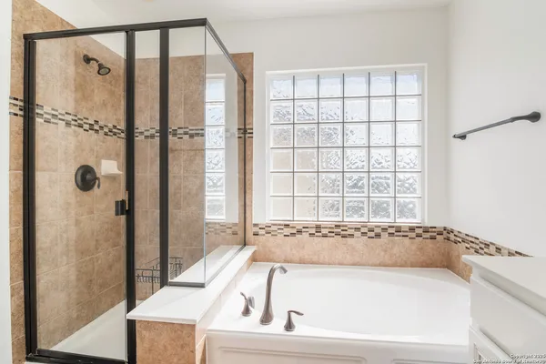 a bathroom with a tub and a shower