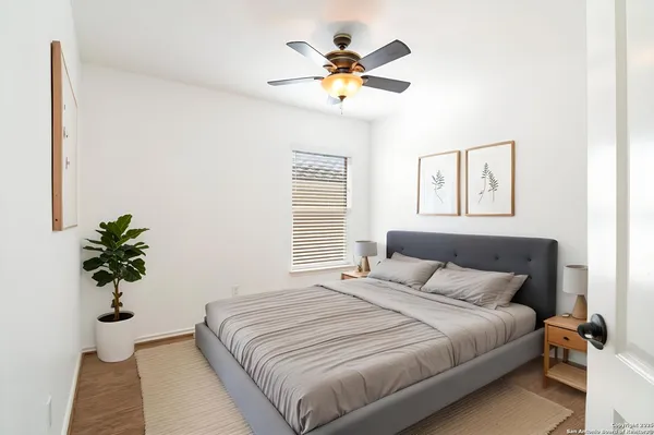 a bedroom with a large bed and a chandelier