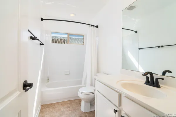 a bathroom with a sink a toilet and a large mirror