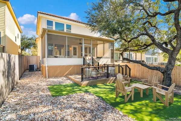 a view of a house with backyard and sitting area
