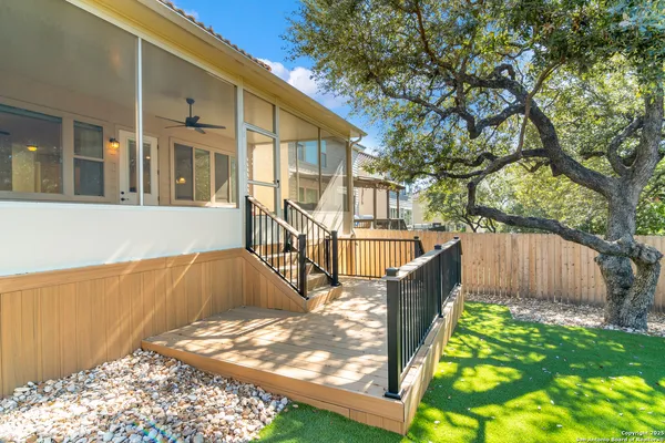 a view of a house with backyard and sitting area