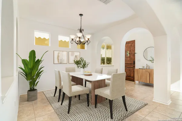 a view of a dining room with furniture and chandelier