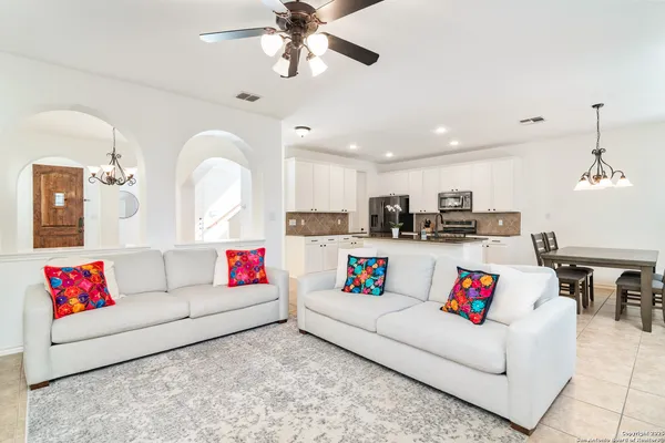 a living room with furniture and kitchen view