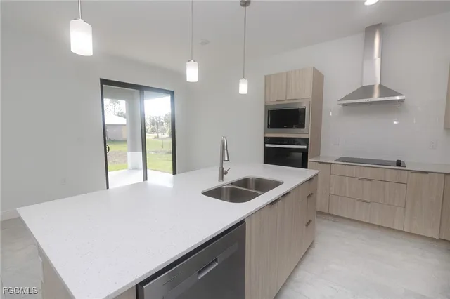 a kitchen with a sink and a stove top oven