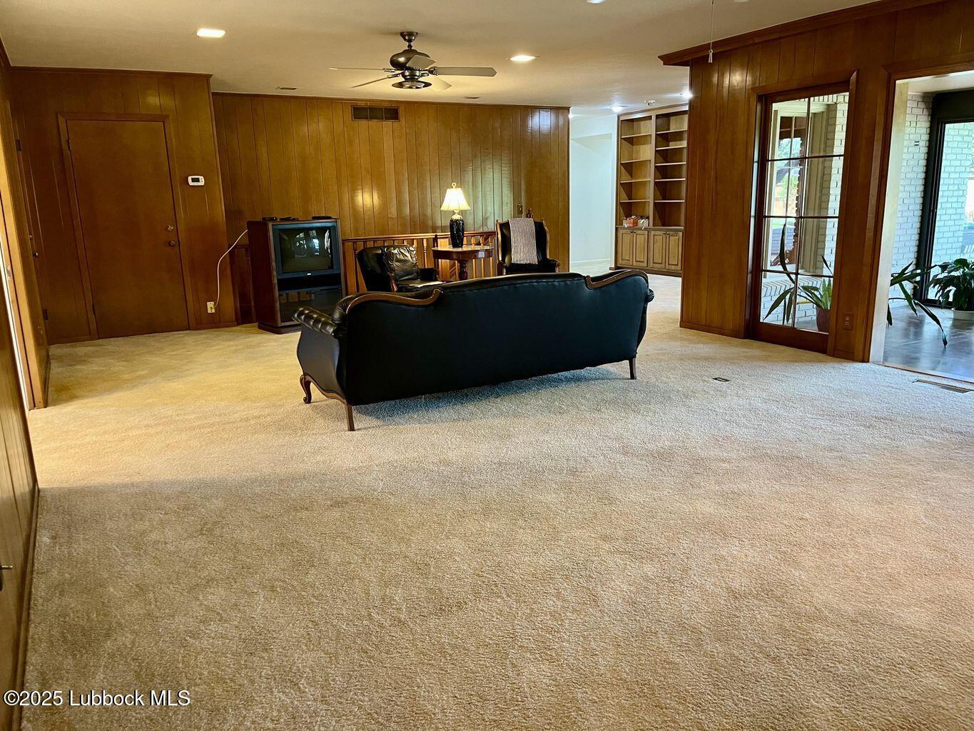 103 Yucca Terrace Plainview, TX 79072 - Photo 15 of 79 a large room with furniture and a flat screen tv