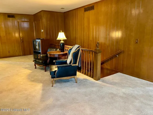 a view of an empty room with wooden shelves