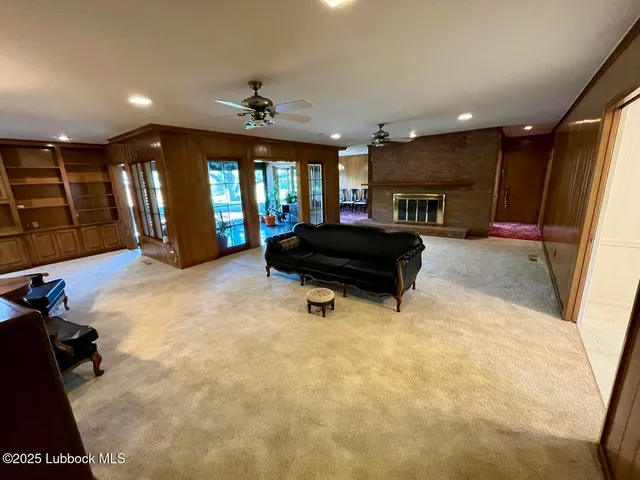 a spacious bedroom with a bed and a flat screen tv