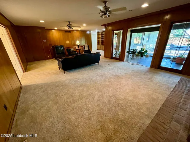a spacious bedroom with a bed dresser and a window