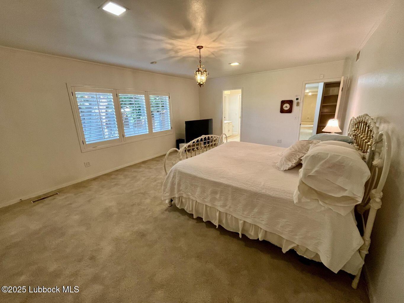103 Yucca Terrace Plainview, TX 79072 - Photo 24 of 79 a spacious bedroom with a bed dresser and a window