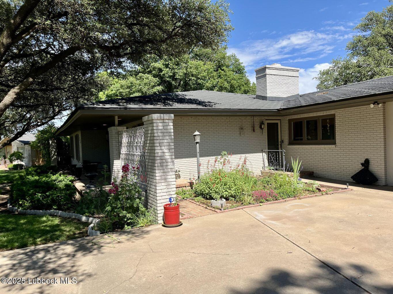 103 Yucca Terrace Plainview, TX 79072 - Photo 3 of 79 a front view of a house with a yard and potted plants