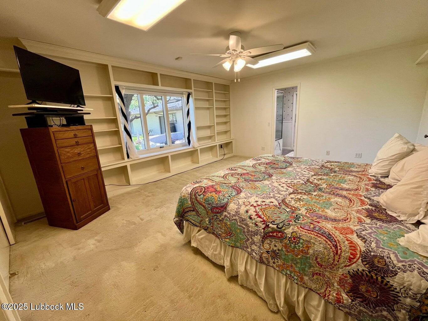 103 Yucca Terrace Plainview, TX 79072 - Photo 42 of 79 a spacious bedroom with a bed and flat screen tv