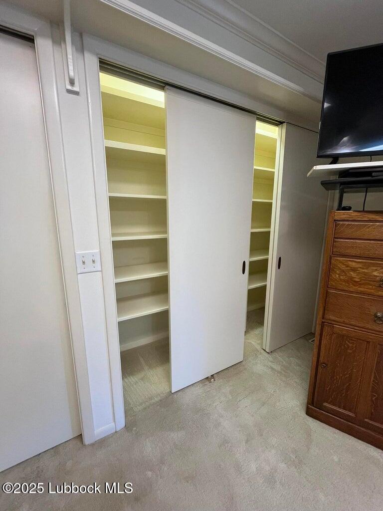 103 Yucca Terrace Plainview, TX 79072 - Photo 43 of 79 a view of walk in closet with empty racks