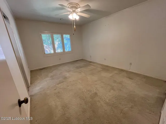 a view of a refrigerator in kitchen and a window