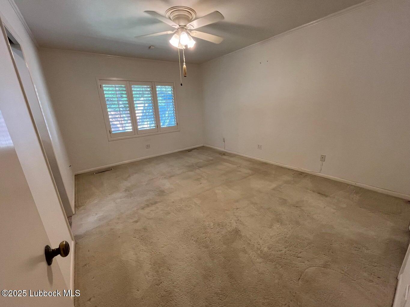 103 Yucca Terrace Plainview, TX 79072 - Photo 44 of 79 an empty room with windows and fan