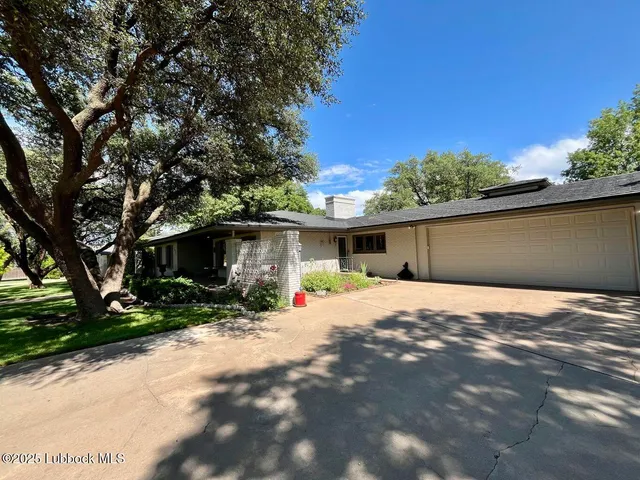 a wooden house with trees in front of it