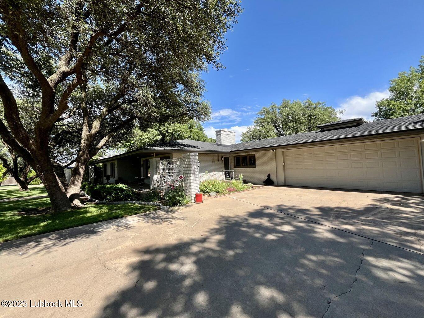 103 Yucca Terrace Plainview, TX 79072 - Photo 6 of 79 a wooden house with trees in front of it