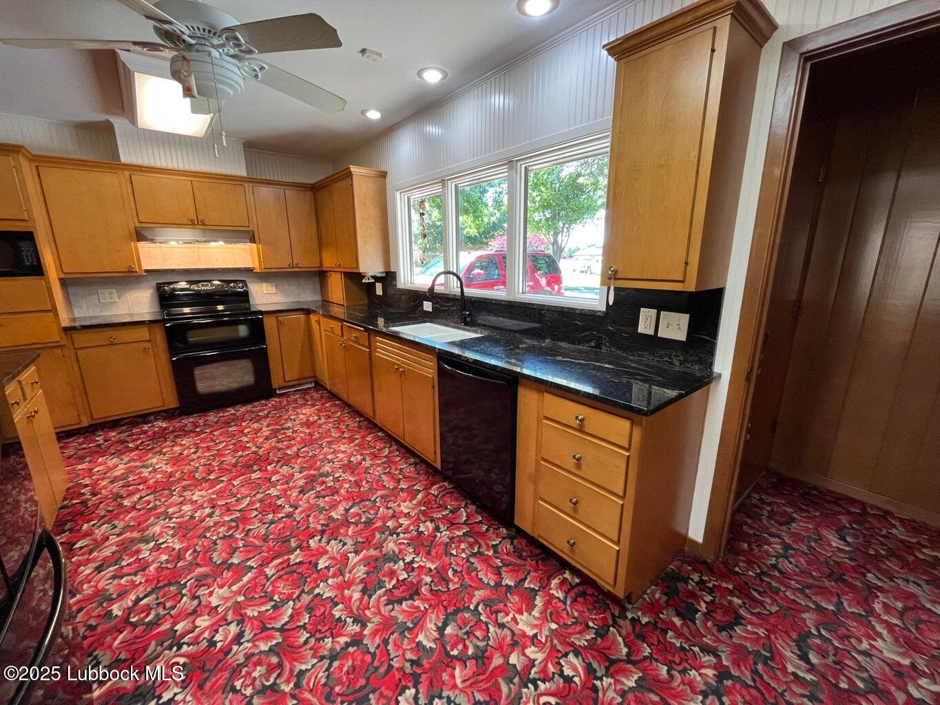 103 Yucca Terrace Plainview, TX 79072 - Photo 64 of 79 a kitchen with stainless steel appliances granite countertop a stove a sink and a microwave