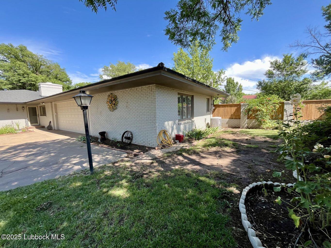 103 Yucca Terrace Plainview, TX 79072 - Photo 8 of 79 a view of a backyard with a garden