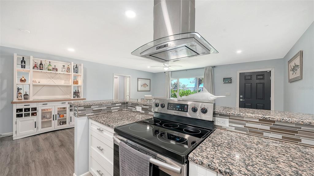 972 Leeward Road Venice, FL 34293 - Photo 11 of 27 a kitchen with stainless steel appliances granite countertop a stove and a sink