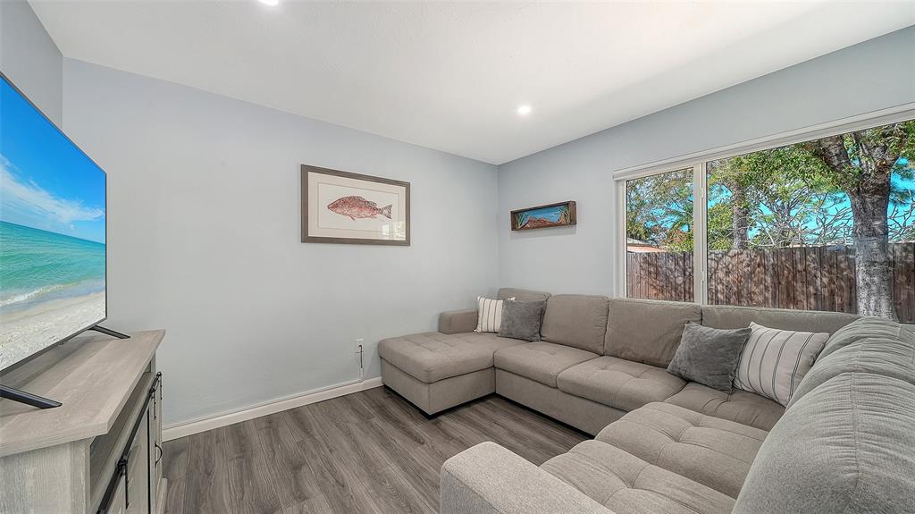 972 Leeward Road Venice, FL 34293 - Photo 13 of 27 a living room with furniture and a flat screen tv
