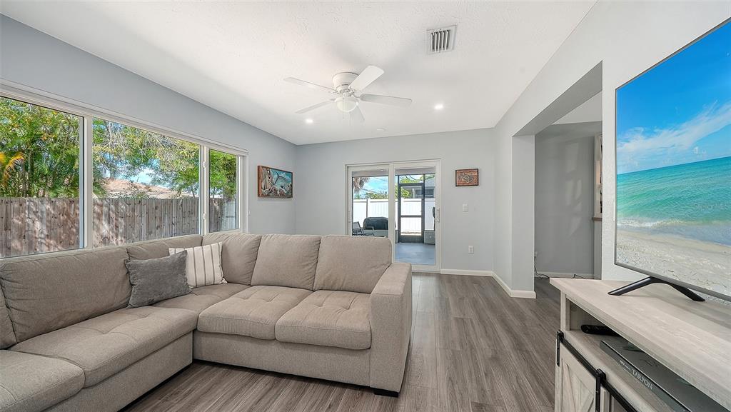 972 Leeward Road Venice, FL 34293 - Photo 14 of 27 a living room with furniture and a flat screen tv