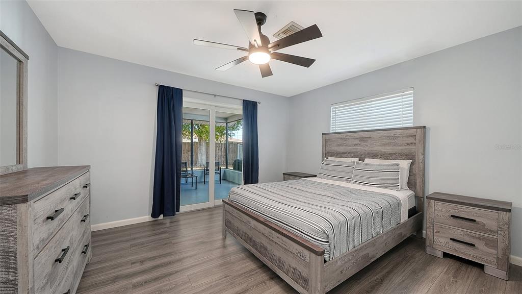 972 Leeward Road Venice, FL 34293 - Photo 15 of 27 a bedroom with a bed and a dresser